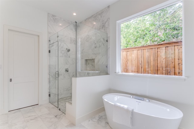 bathroom featuring separate shower and tub