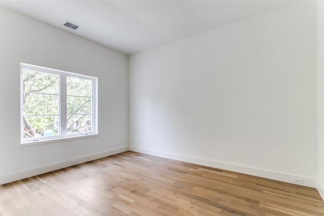 unfurnished room with light hardwood / wood-style floors