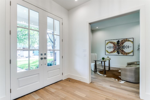 doorway to outside with plenty of natural light, light wood-type flooring, and french doors