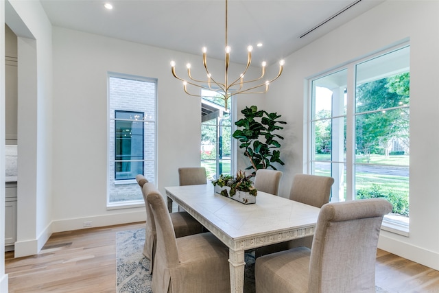 dining room with a notable chandelier and light hardwood / wood-style flooring