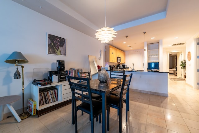 dining space with sink and light tile floors