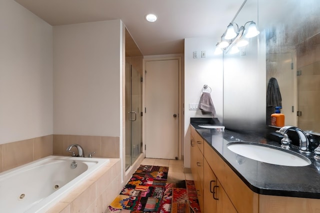 bathroom featuring independent shower and bath, double vanity, and tile flooring