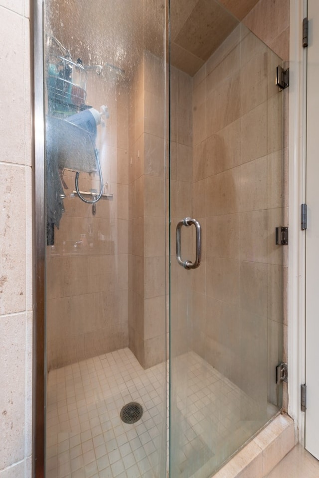 bathroom with a shower with door