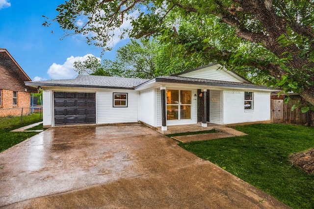 ranch-style house with a garage and a front lawn