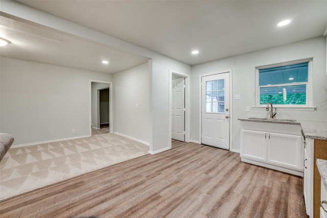 carpeted entryway with sink