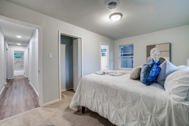 carpeted bedroom with multiple windows