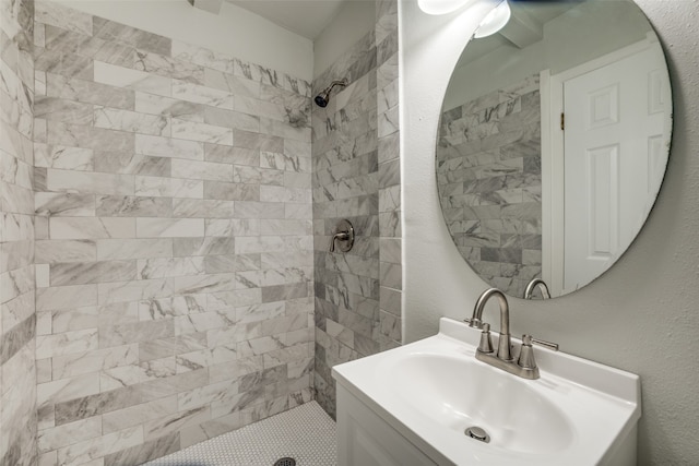 bathroom featuring vanity and a tile shower