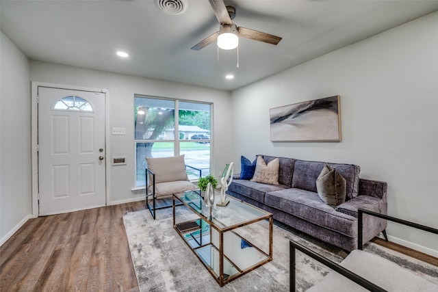 living room featuring hardwood / wood-style flooring and ceiling fan