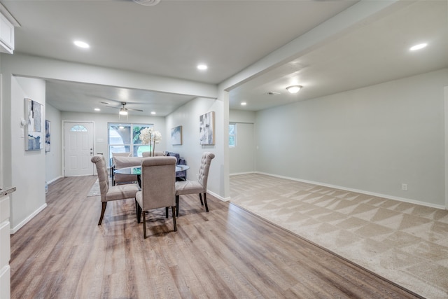 carpeted dining room featuring ceiling fan