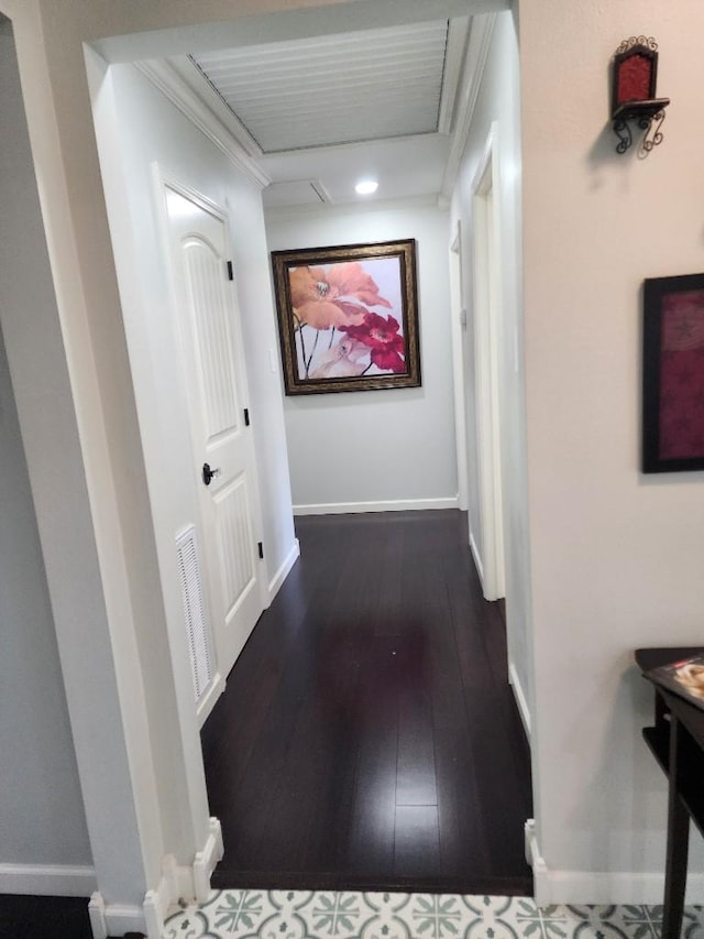 hall featuring crown molding and dark hardwood / wood-style floors