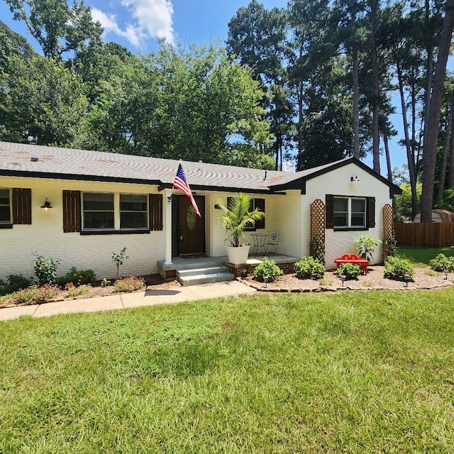 ranch-style home featuring a front yard