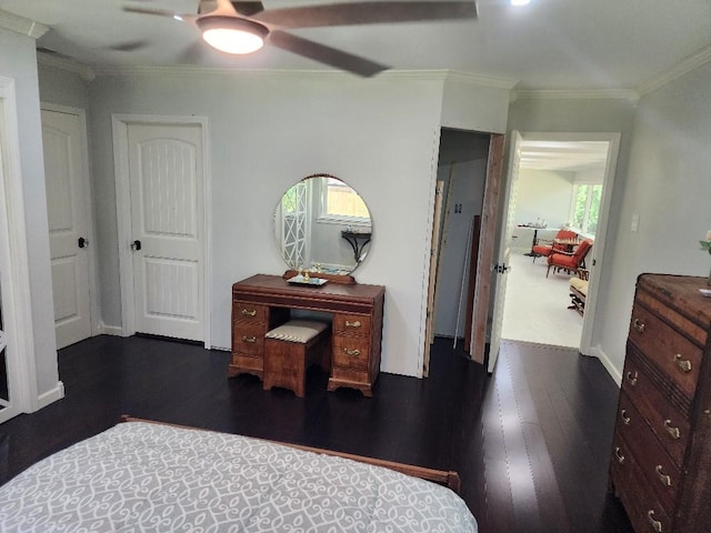 bedroom featuring dark hardwood / wood-style flooring, crown molding, and ceiling fan