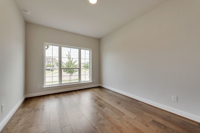 empty room featuring baseboards and wood finished floors