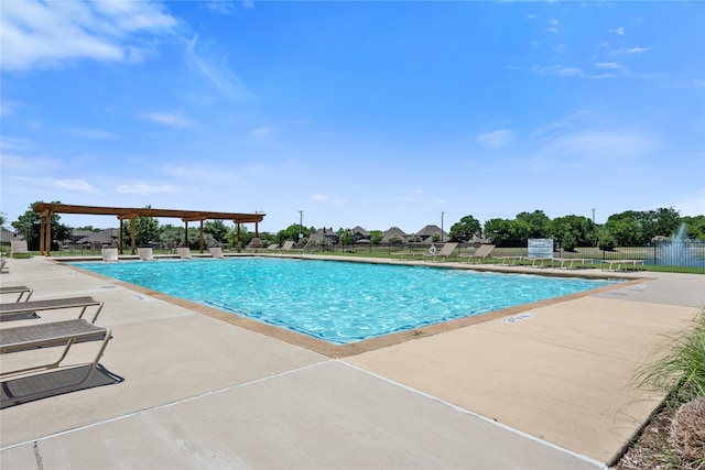 community pool with a patio area, a pergola, and fence