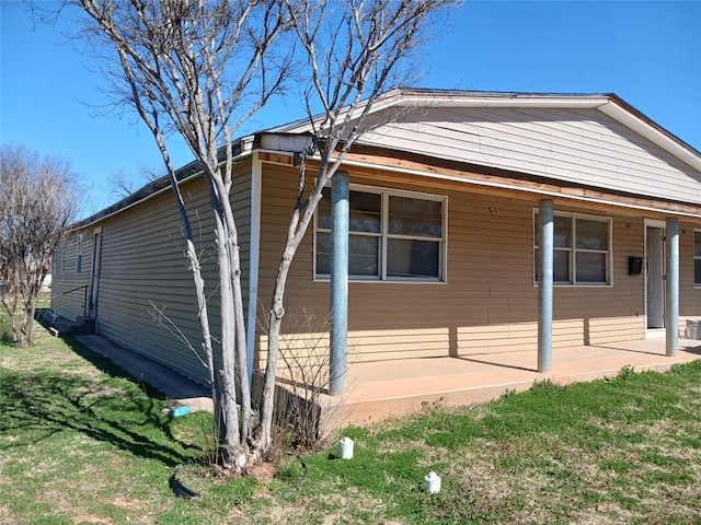 view of side of home featuring a lawn