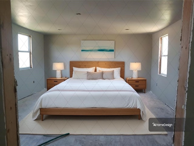 bedroom featuring tile walls and multiple windows