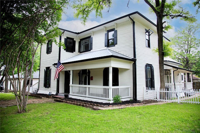 view of front of property with a porch and a front lawn