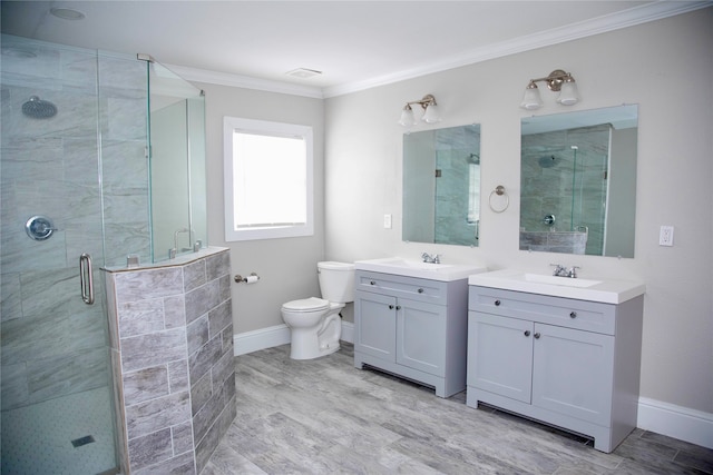 bathroom with ornamental molding, an enclosed shower, toilet, and vanity