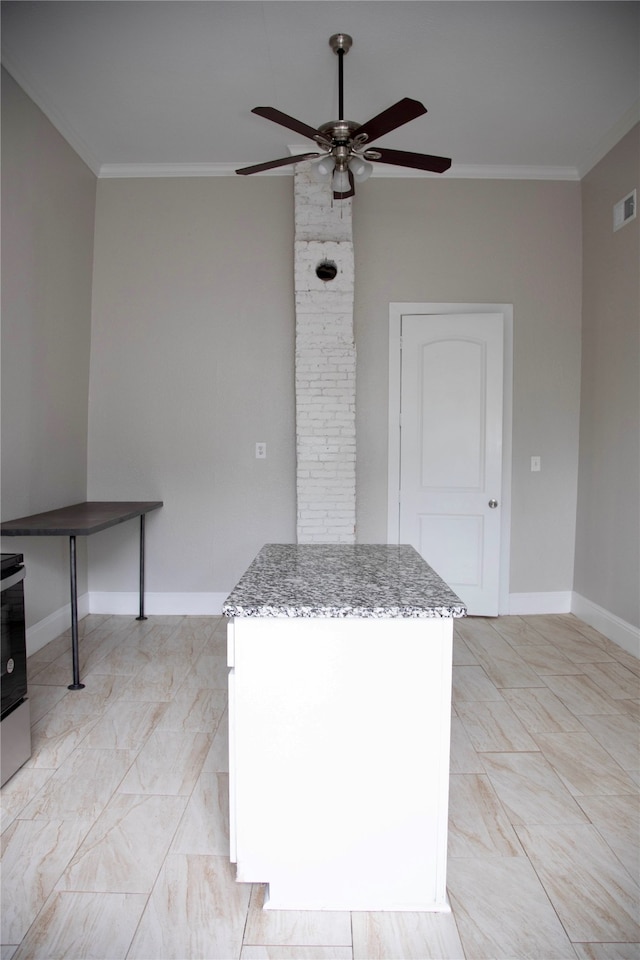 kitchen featuring brick wall, ornamental molding, ceiling fan, and light tile floors