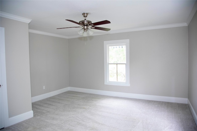 empty room with ornamental molding, ceiling fan, and carpet flooring