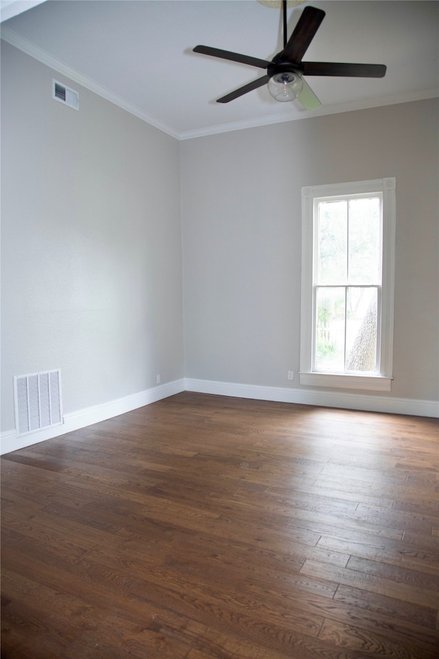 empty room with crown molding, dark hardwood / wood-style flooring, and ceiling fan