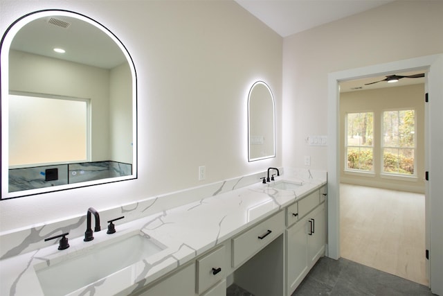 bathroom with double vanity, tile patterned flooring, ceiling fan, and a sink