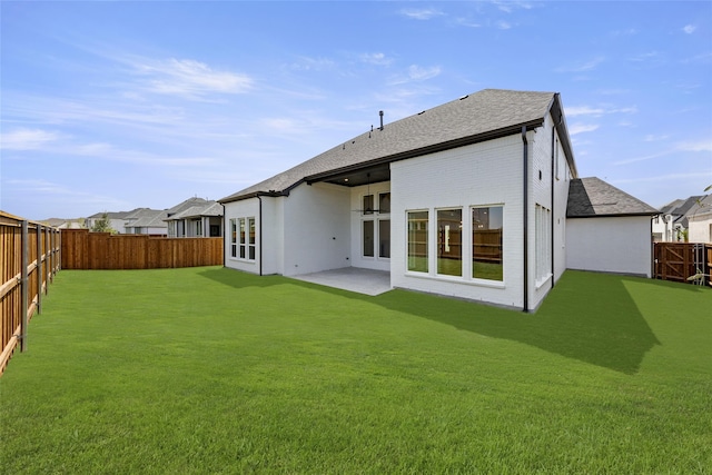 back of property featuring a lawn and a patio area