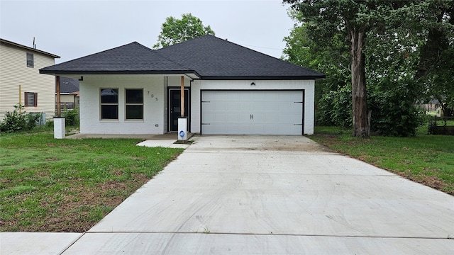 view of front of house with a garage and a front lawn