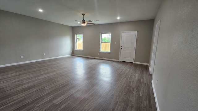 unfurnished room with dark hardwood / wood-style floors and ceiling fan