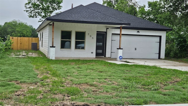 view of front of house with a front yard and a garage