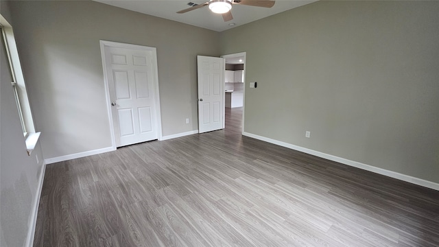 unfurnished bedroom featuring ceiling fan and hardwood / wood-style flooring