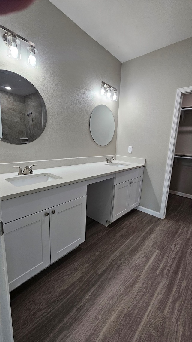 bathroom with hardwood / wood-style floors and dual bowl vanity