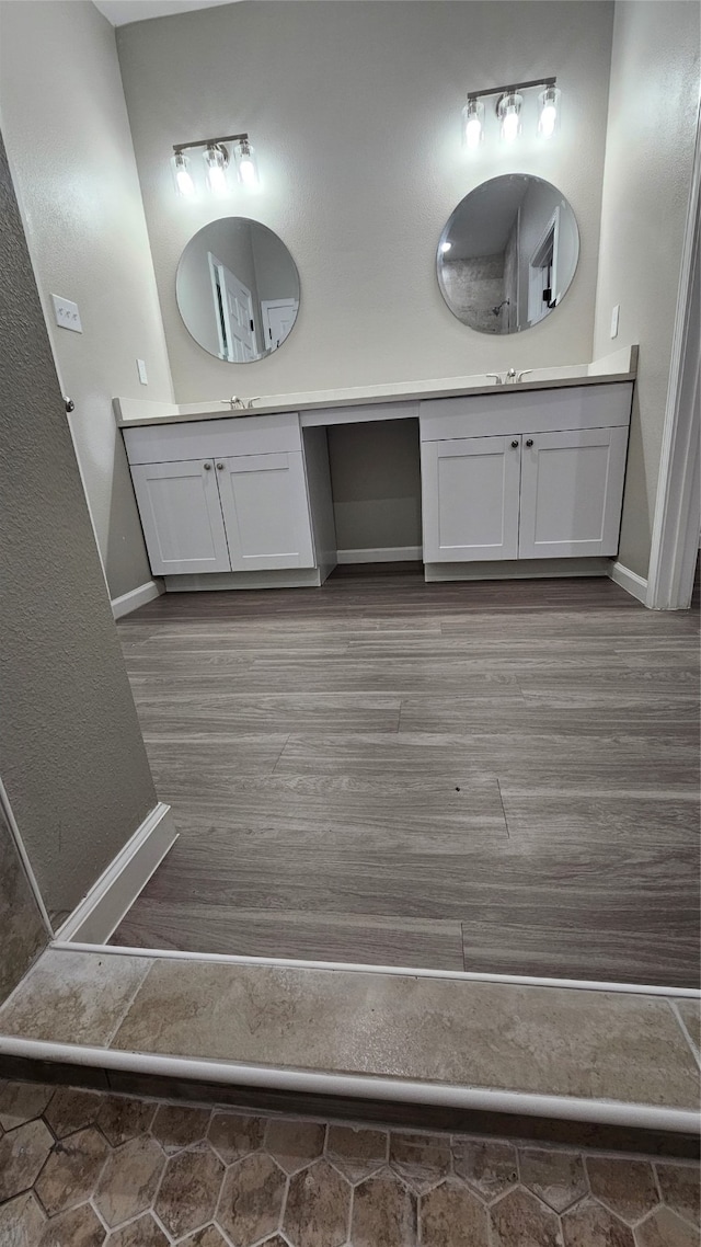 bathroom featuring hardwood / wood-style floors and double sink vanity