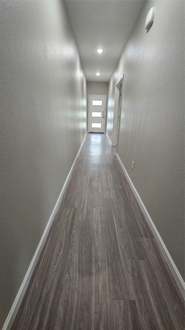 corridor featuring dark hardwood / wood-style flooring