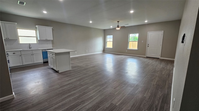 kitchen with a kitchen island, ceiling fan, tasteful backsplash, white cabinets, and dark hardwood / wood-style flooring