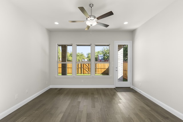 spare room with ceiling fan, dark hardwood / wood-style floors, and plenty of natural light