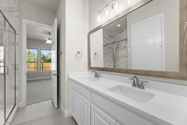 bathroom with ceiling fan, a shower with door, vanity, and tile patterned flooring