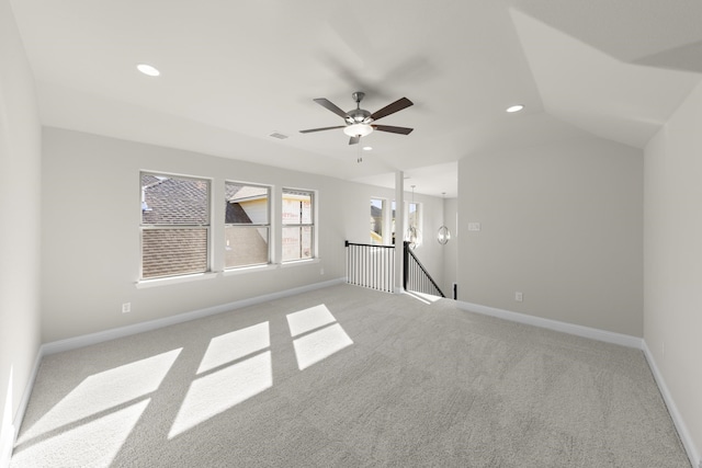 interior space with ceiling fan, light colored carpet, and vaulted ceiling