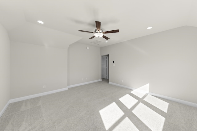 carpeted empty room featuring vaulted ceiling and ceiling fan