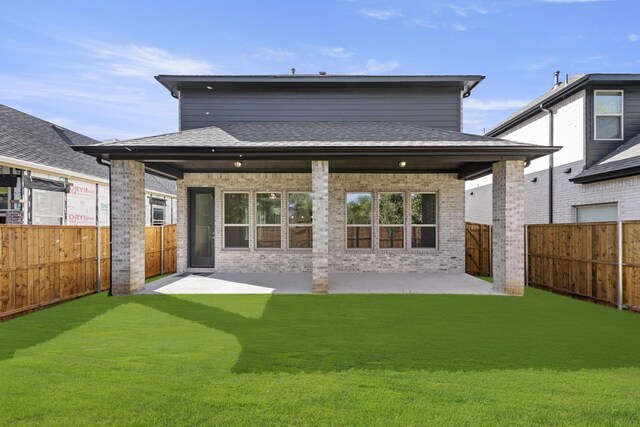 back of house with a yard and a patio