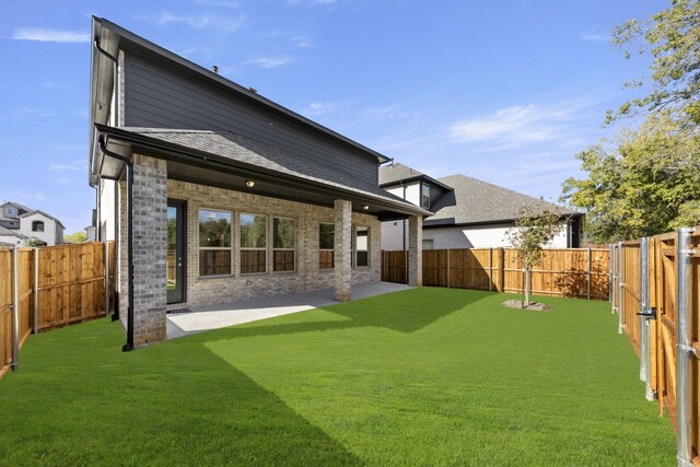 back of property featuring a yard and a patio area