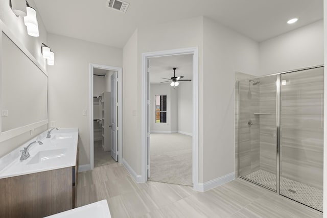 bathroom with an enclosed shower, vanity, and ceiling fan