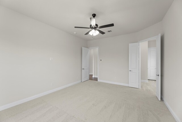 unfurnished bedroom with ceiling fan and light carpet