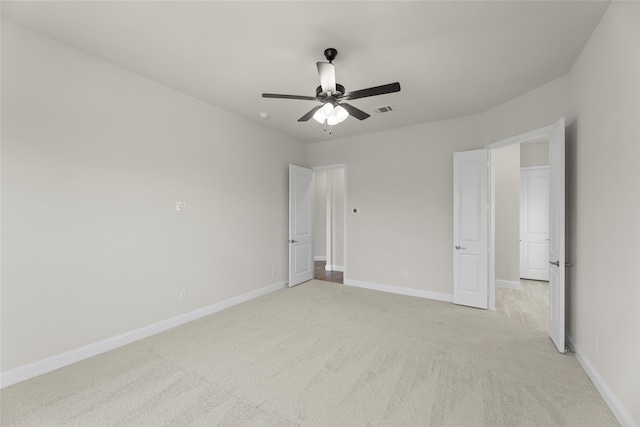 unfurnished bedroom featuring ceiling fan and light carpet