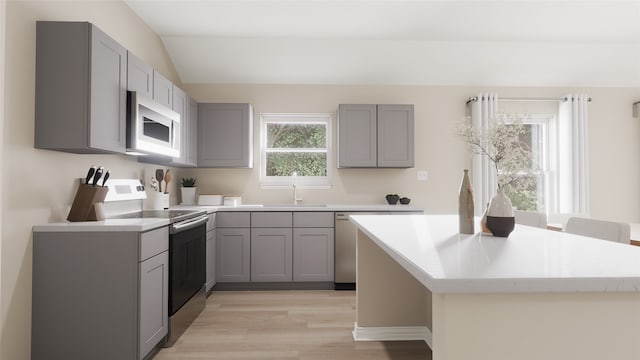 kitchen featuring electric range, sink, light wood-type flooring, and gray cabinetry