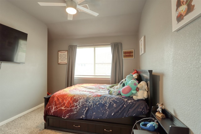 carpeted bedroom featuring lofted ceiling and ceiling fan