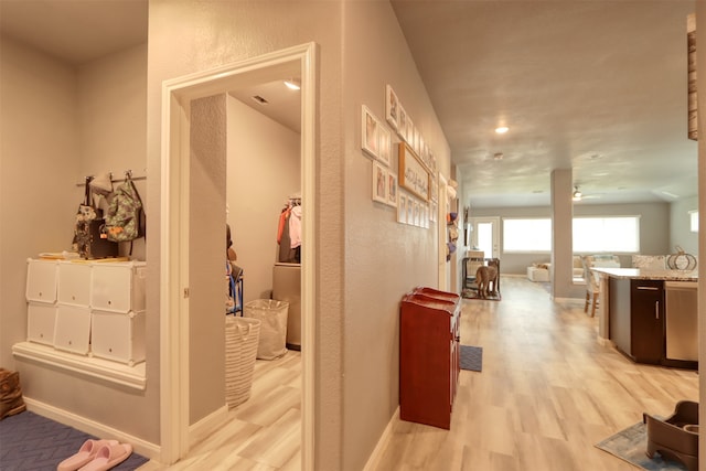 corridor with light hardwood / wood-style floors