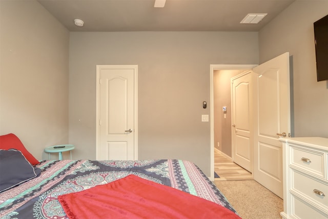 bedroom with light colored carpet, a closet, and ceiling fan