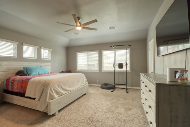 bedroom with light carpet, ceiling fan, and multiple windows