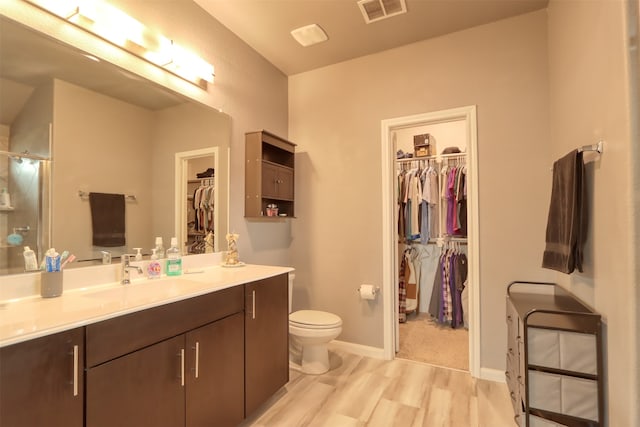 bathroom with large vanity and toilet